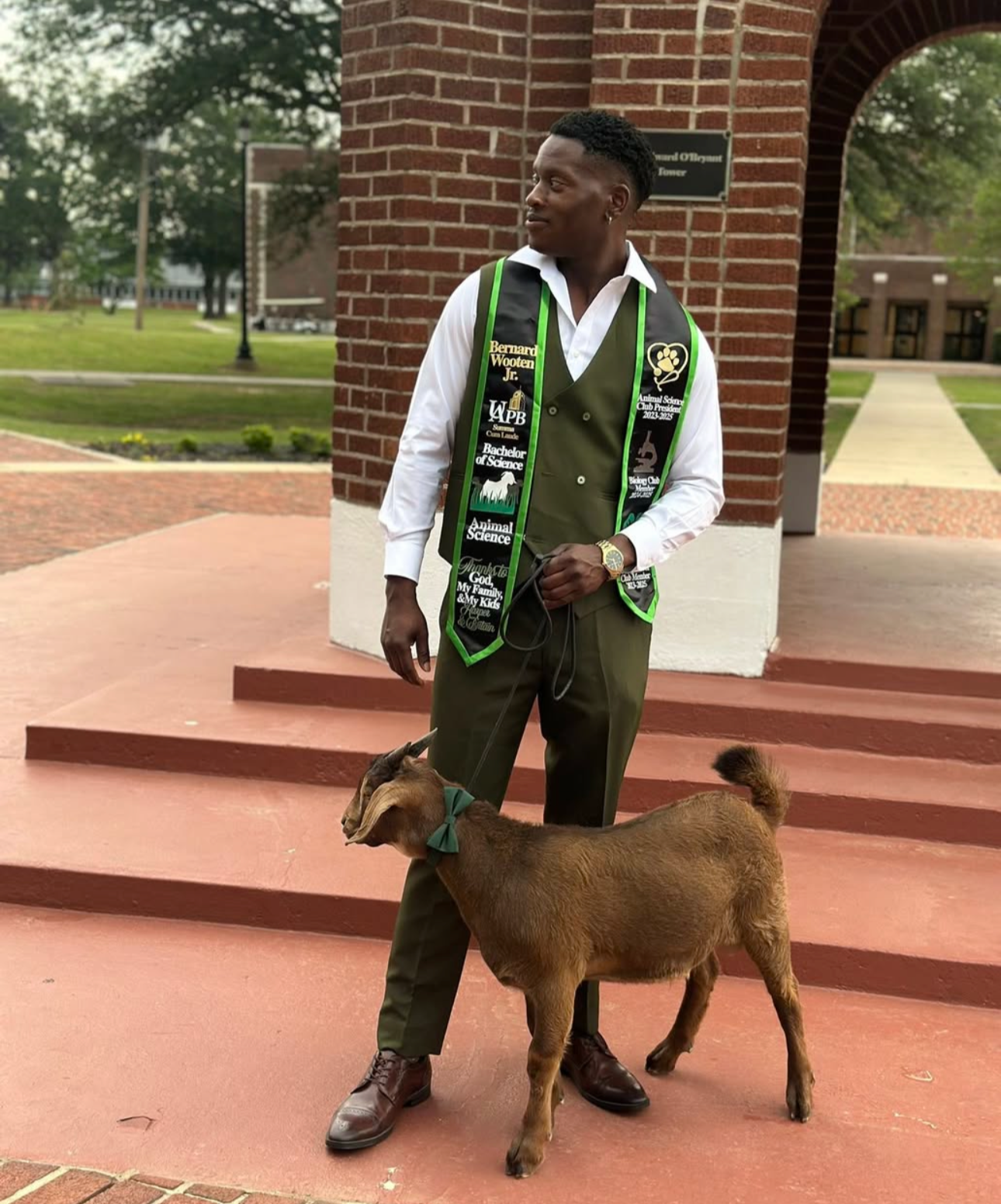 Graduation picture with a goat and custom, handmade, green and black, satin graduation stole